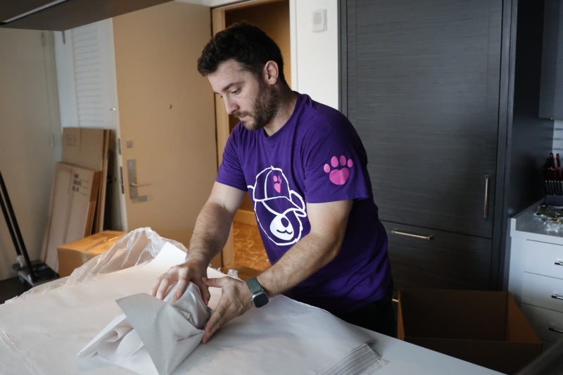 Teddy Moving's mover carefully packing kitchen items during a move in NYC