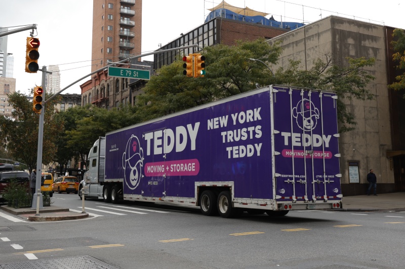 Teddy Moving & Storage's truck trailer for long distance moves, driving through NYC