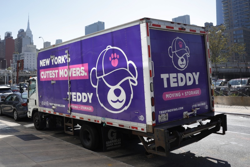 Teddy Moving & Storage's truck parked during a move in NYC on a sunny day